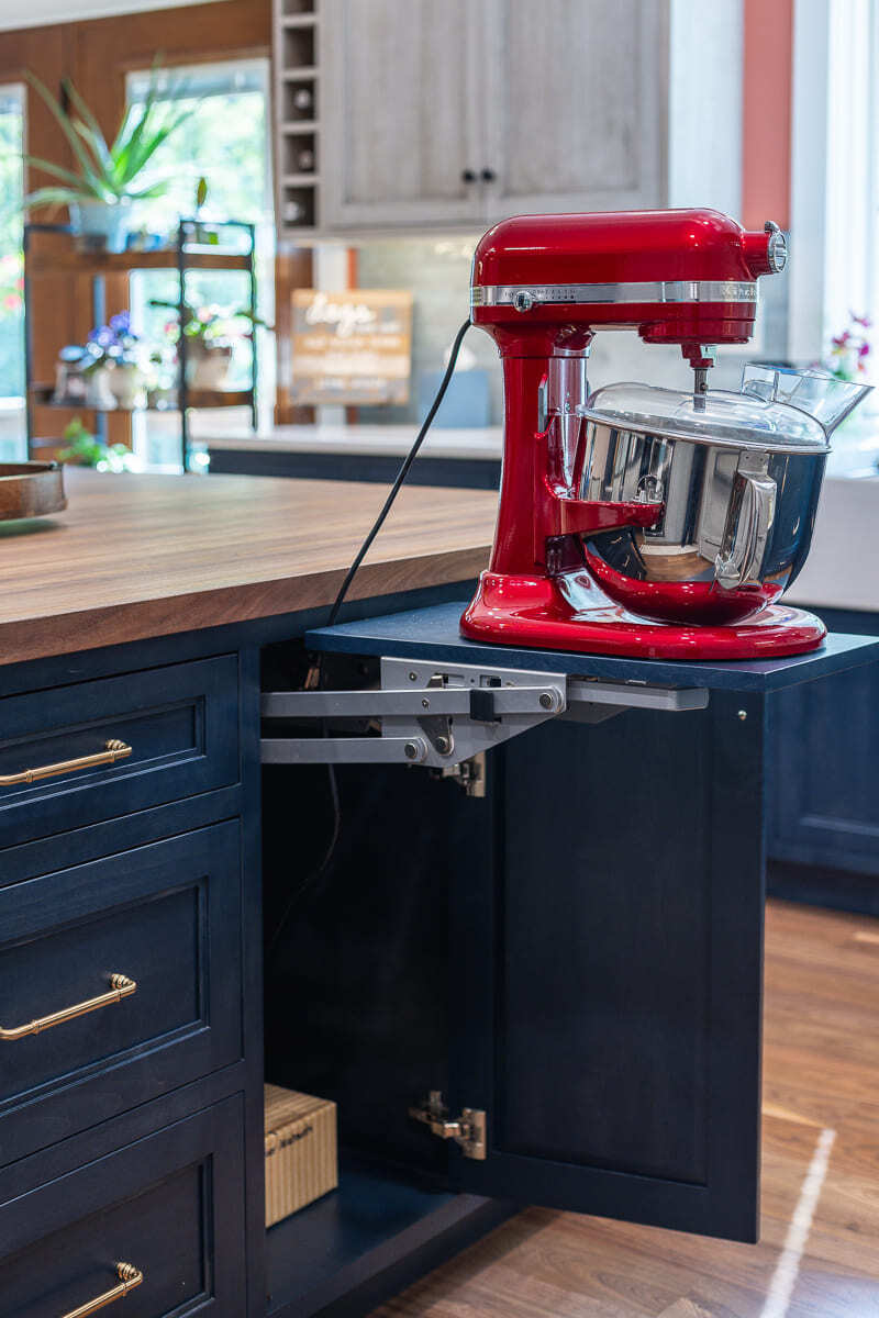 Custom kitchen island mixer lift with Amish-built cabinetry, wood countertop, and smart storage design.