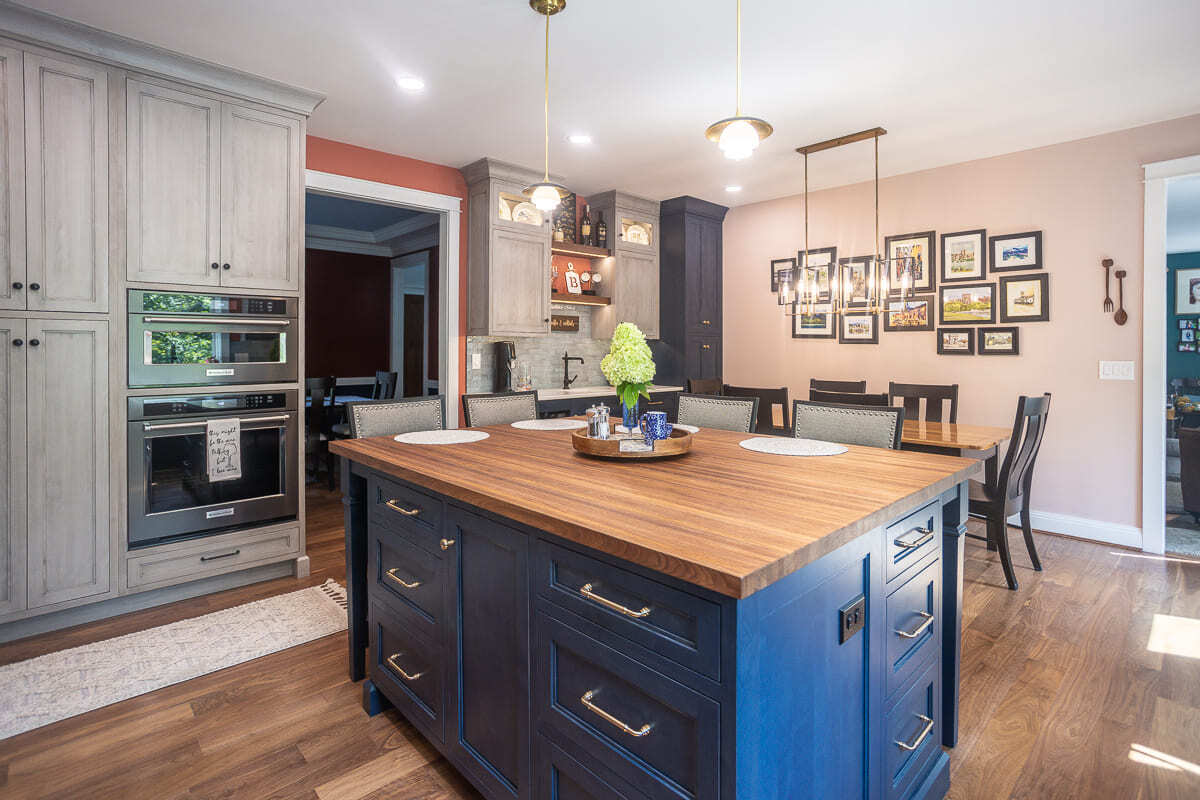 Kitchen remodel by Legacy Builders Group with Amish-built cabinets, wood island top, and built-in double ovens.