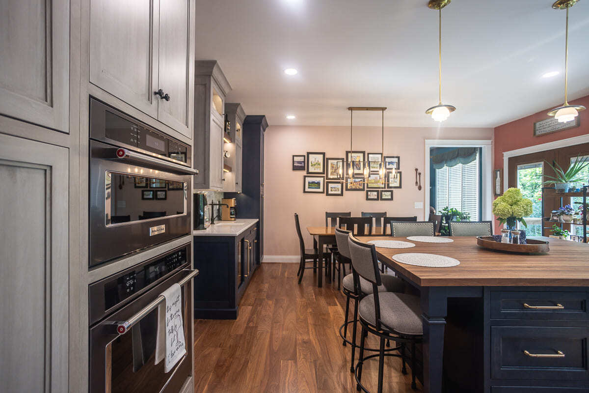 Remodeled kitchen with Amish-built cabinets, double ovens, large island, and connected dining space.