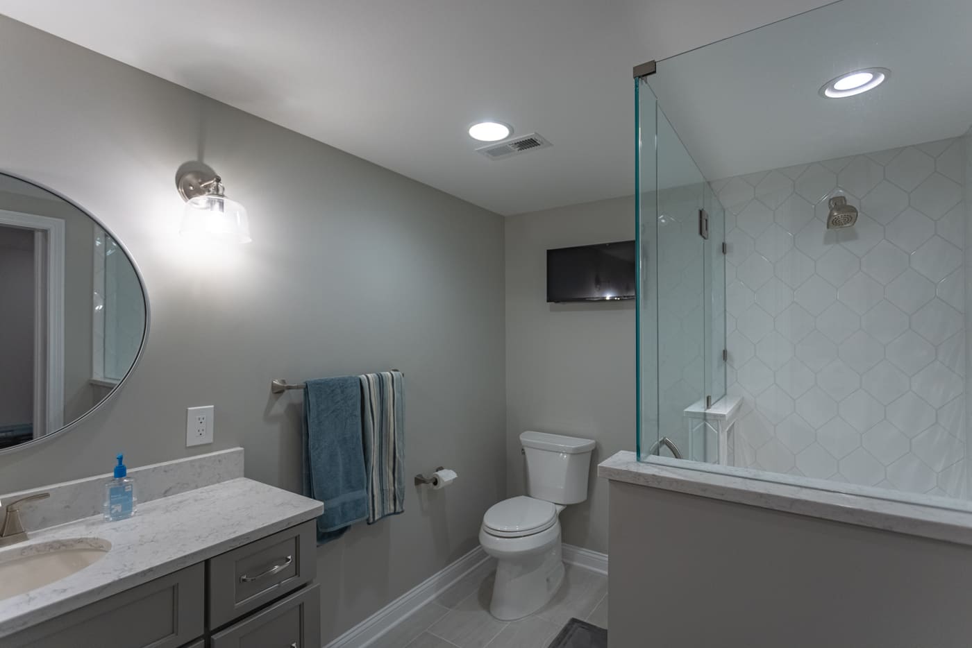 Basement bathroom renovation with walk-in shower and recessed lighting in Ross County, OH
