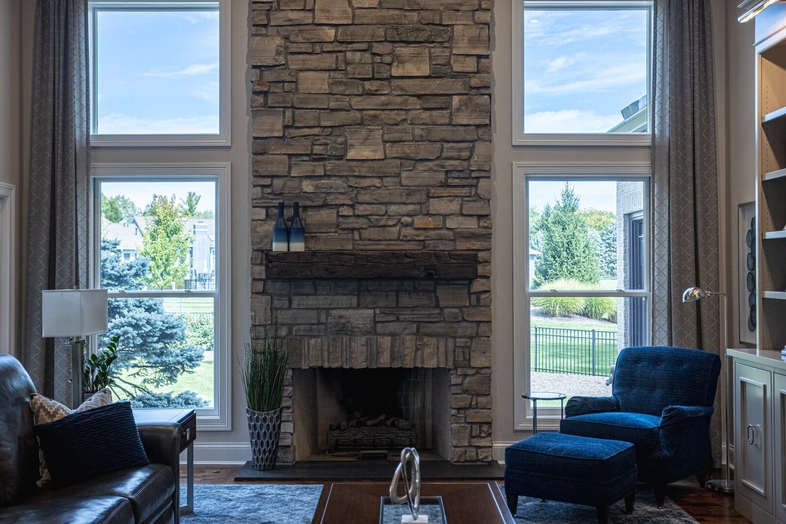Front shot of family room remodel with stone front and leathered granite hearth