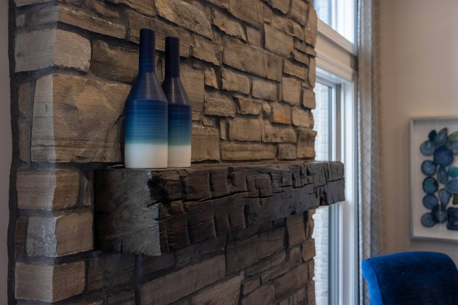 Details of stone fireplace in family room with custom mantel