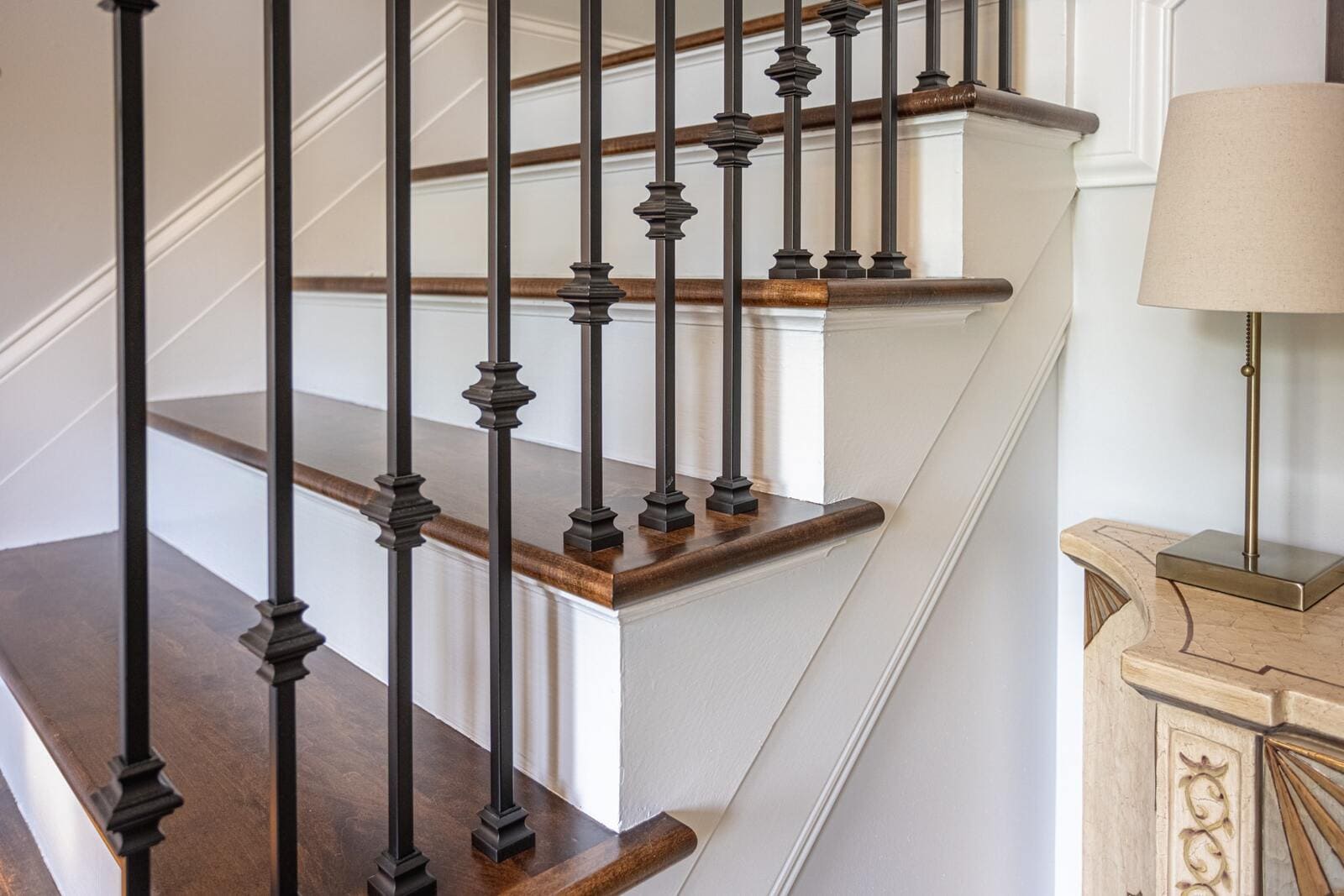 Staircase detail in foyer with iron balusters