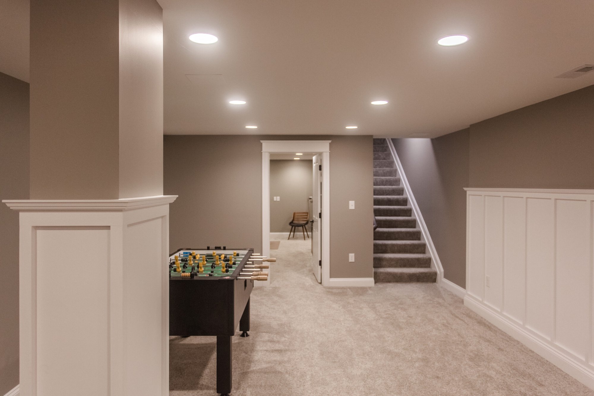 Amberly Village, OH basement with carpeted stairs, foosball table, and open rec room