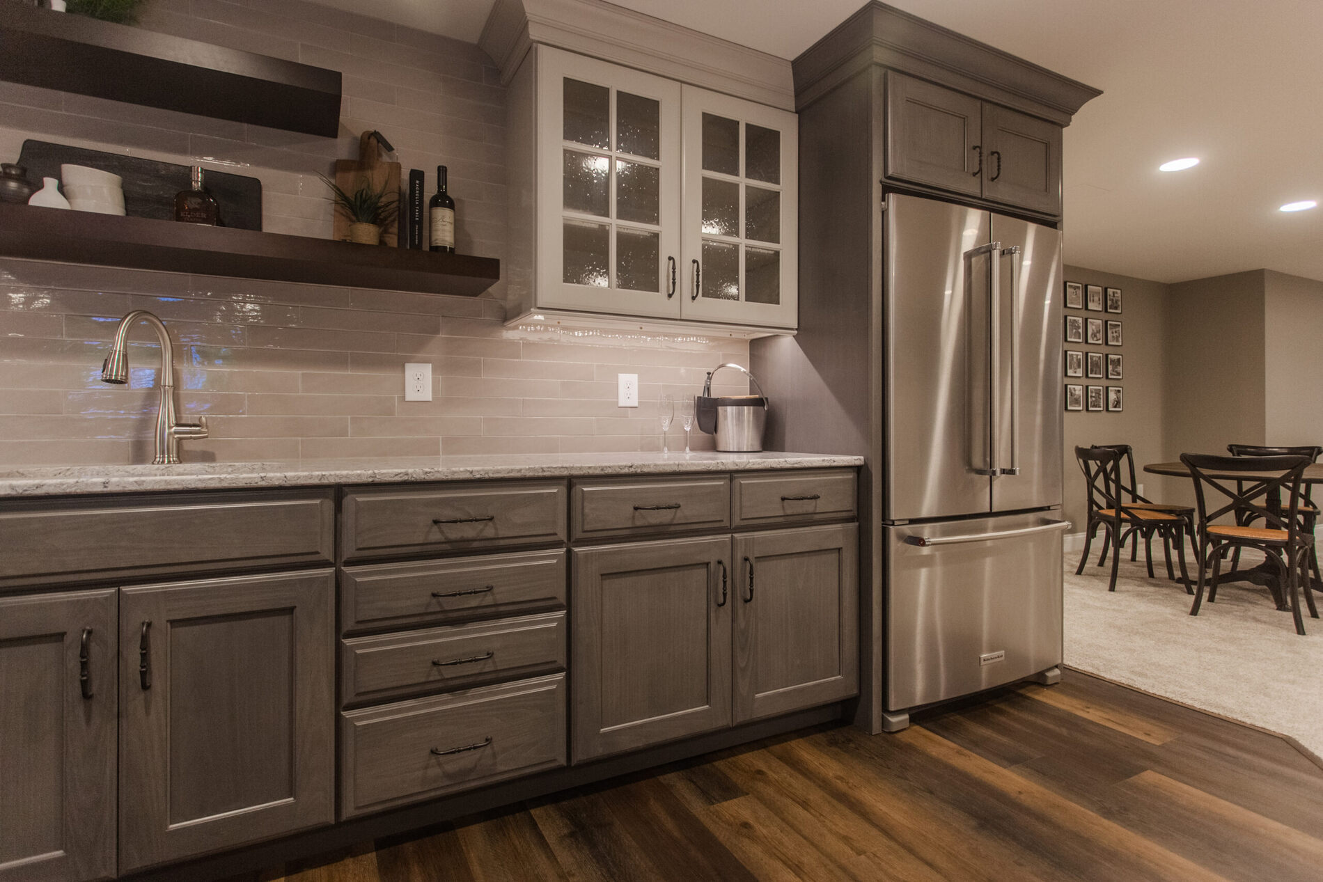 Amberly Village, OH wet bar with gray cabinets, stainless fridge, sink, and floating shelves