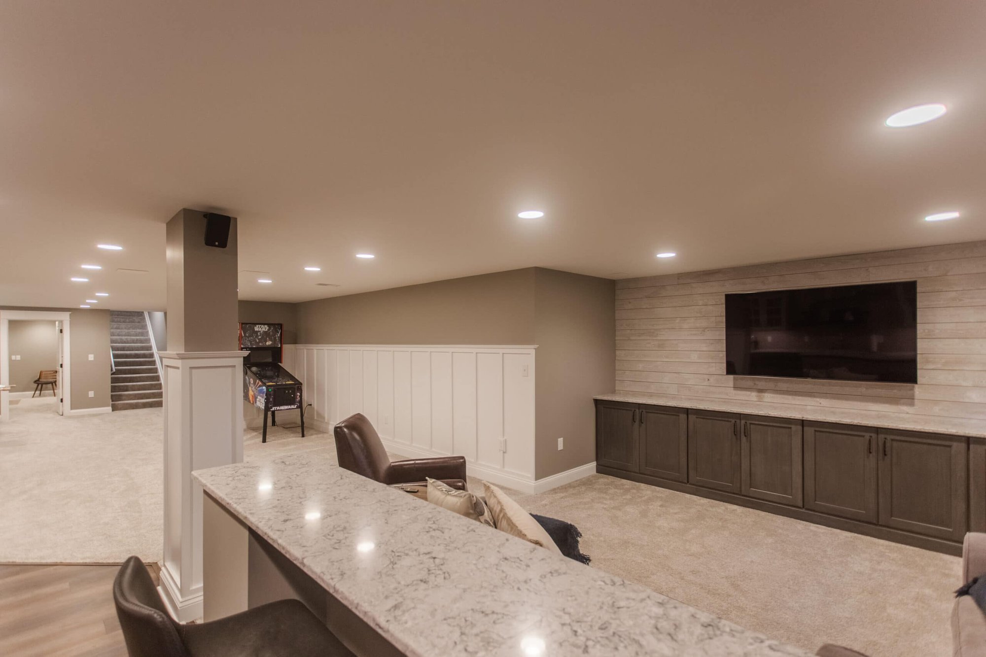 Amberly Village, oh, OH finished basement with granite bar, built-in media wall, recessed lighting, and open recreation area