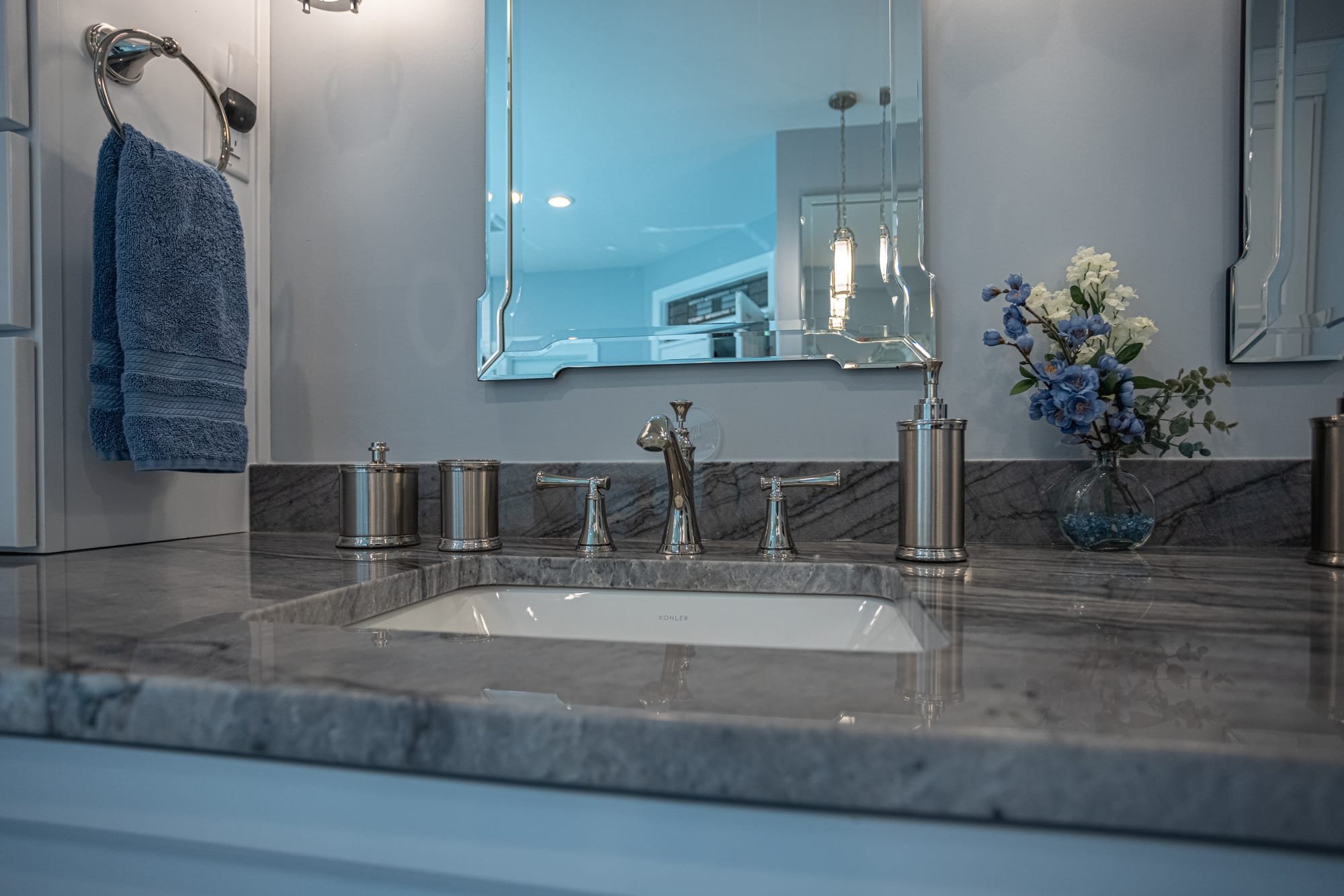 Bathroom sink with marble countertop, chrome faucet, and mirror by Legacy Builders Group in Greater Cincinnati