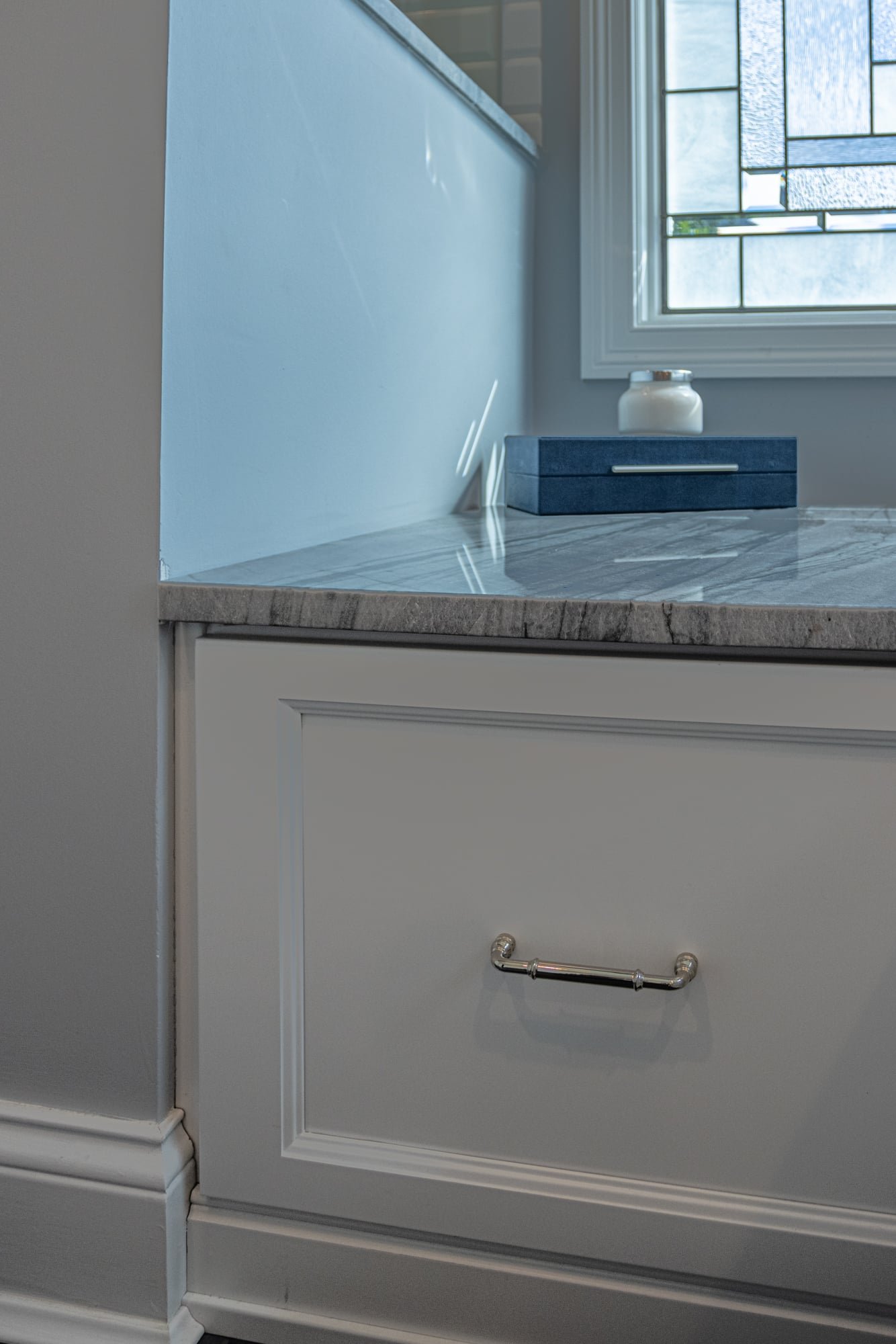Bathroom vanity drawer with marble countertop and brushed hardware by Legacy Builders Group in Greater Cincinnati