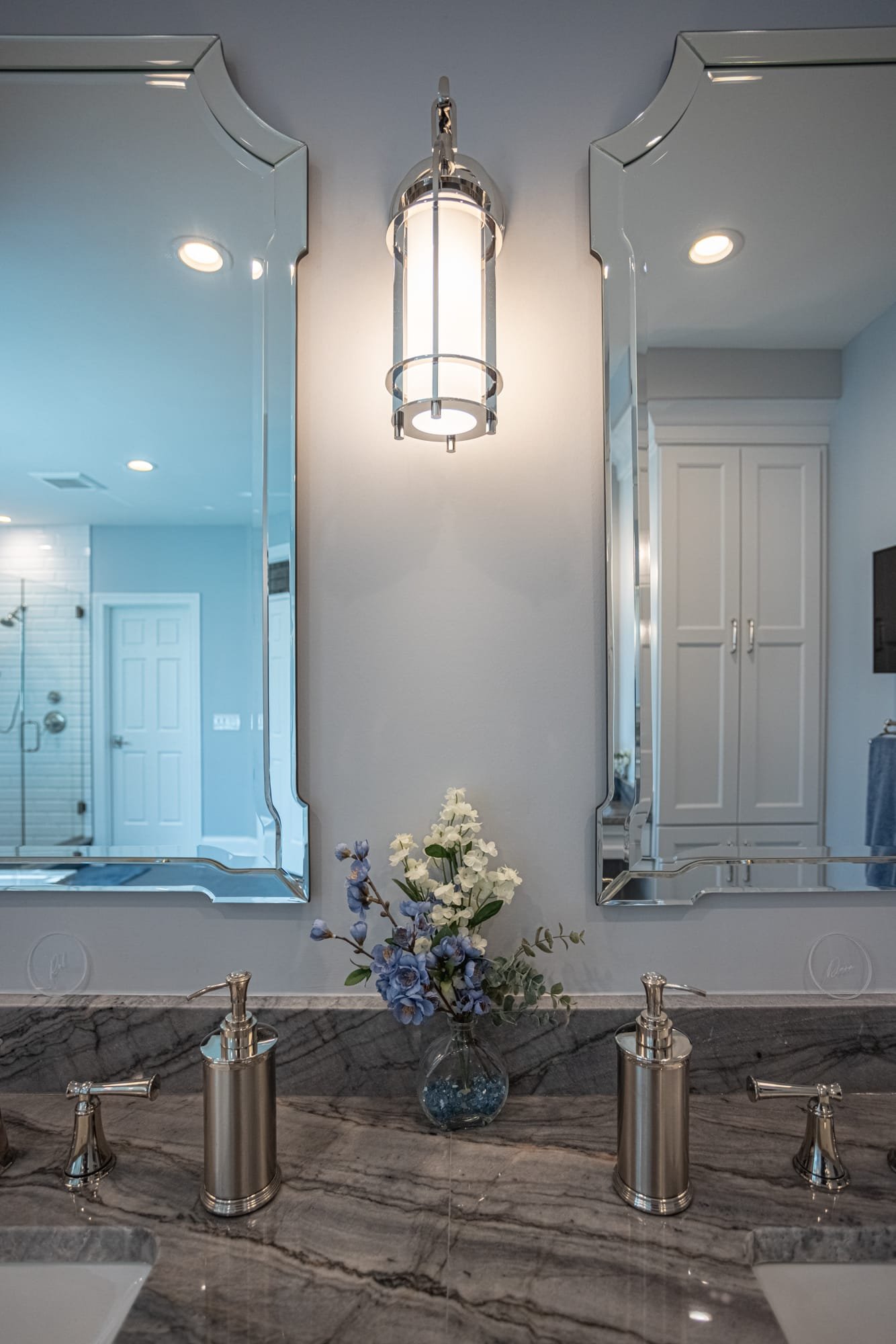 Bathroom vanity with dual mirrors, sconce lighting, and marble countertop by Legacy Builders Group in Greater Cincinnati