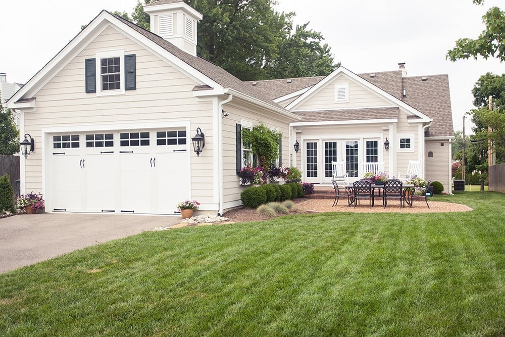 Charming white home addition with garage and outdoor patio space in Cincinnati, Ohio