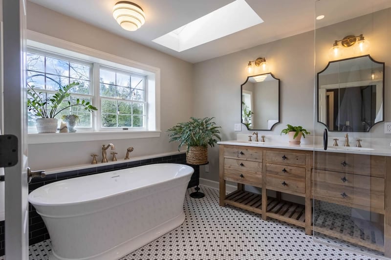 Cincinnati bathroom remodel with double wood vanity and soaking tub by window