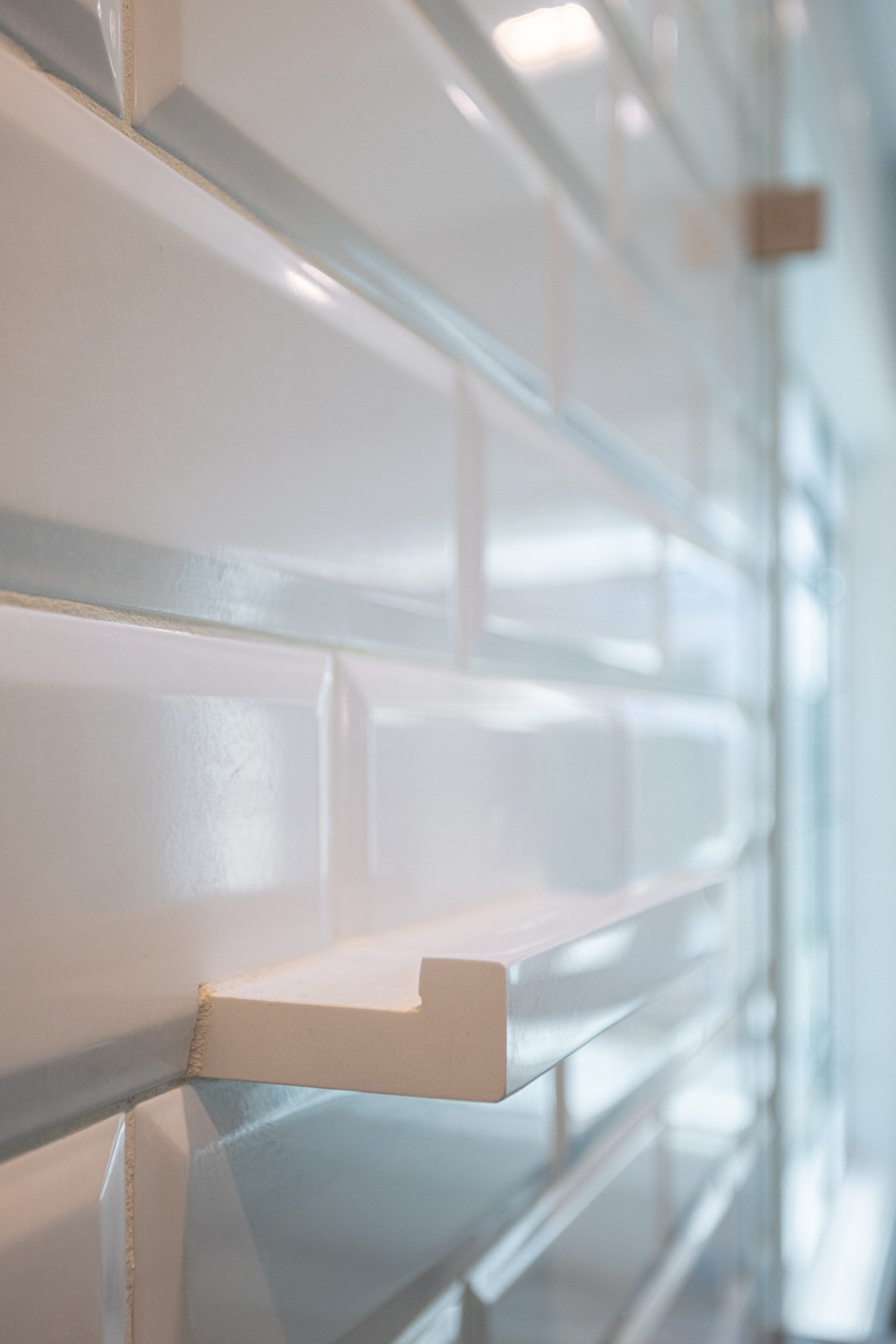 Close-up of white subway tile and trim detail in shower by Legacy Builders Group in Greater Cincinnati