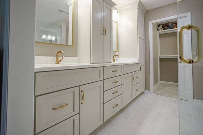 Double bathroom vanity with brass fixtures and walk-in shower in Cincinnati, OH bathroom remodel