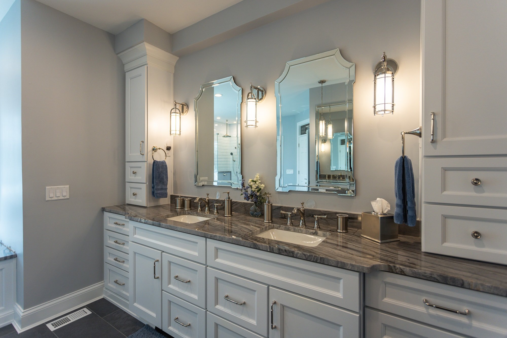 Double vanity with two mirrors, sconce lighting, and marble countertop by Legacy Builders Group in Greater Cincinnati