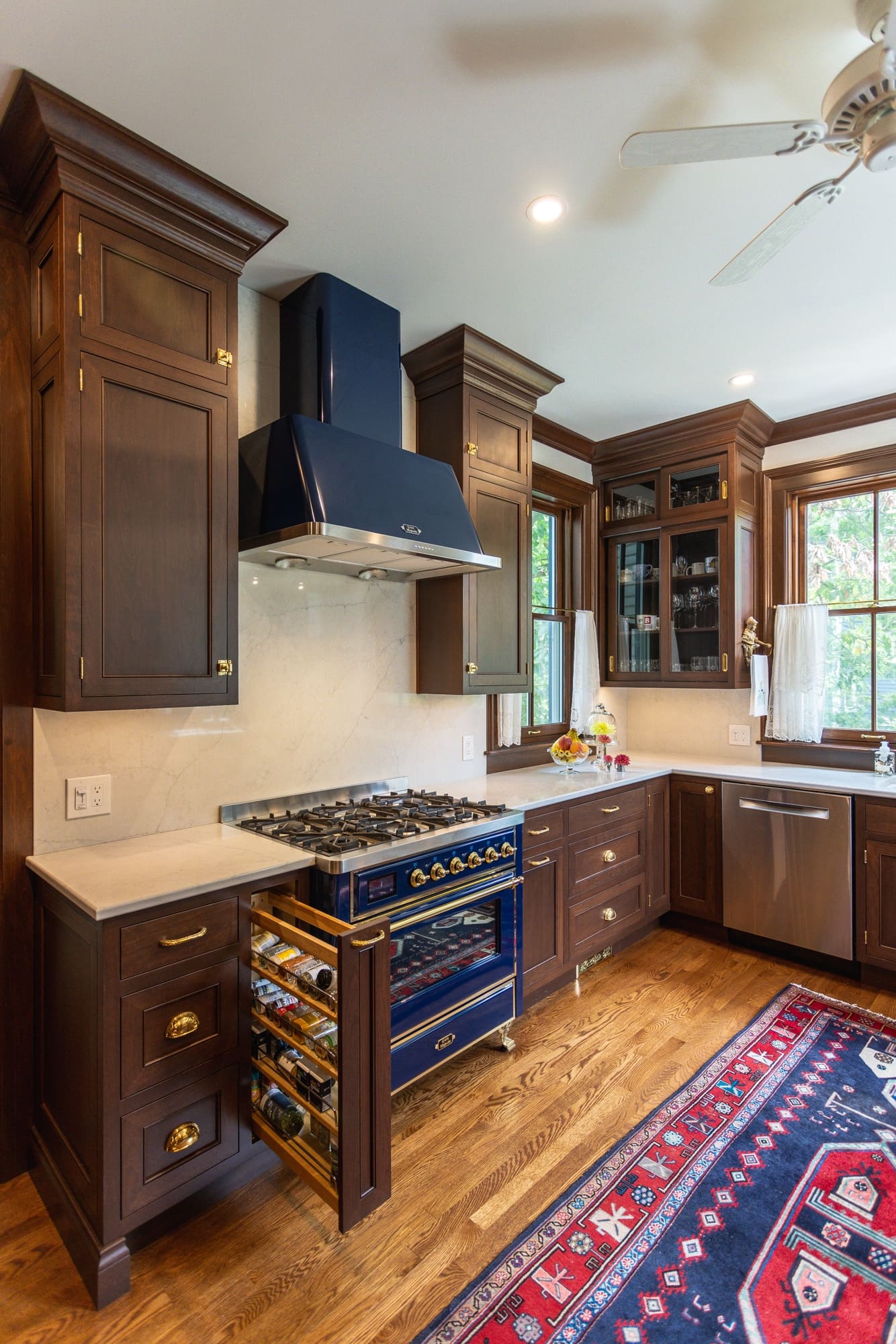 Greater Cincinnati kitchen with a blue range, dark wood cabinetry and a pull-out spice drawer beside the stove