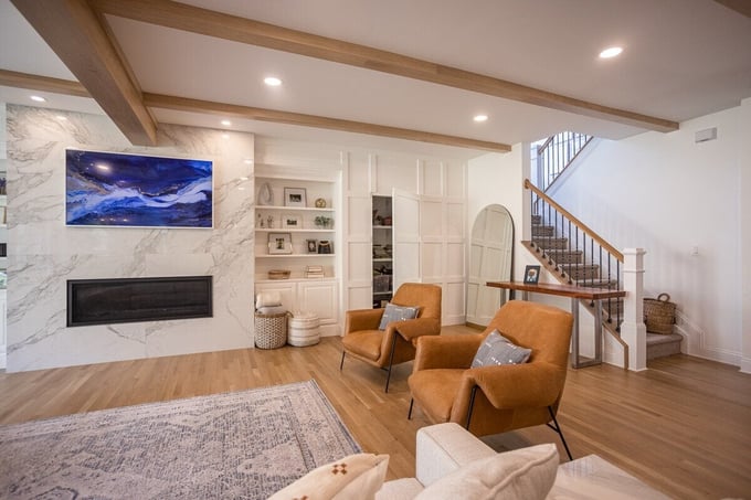 First-floor addition with fireplace and built-in shelving by Legacy Builders