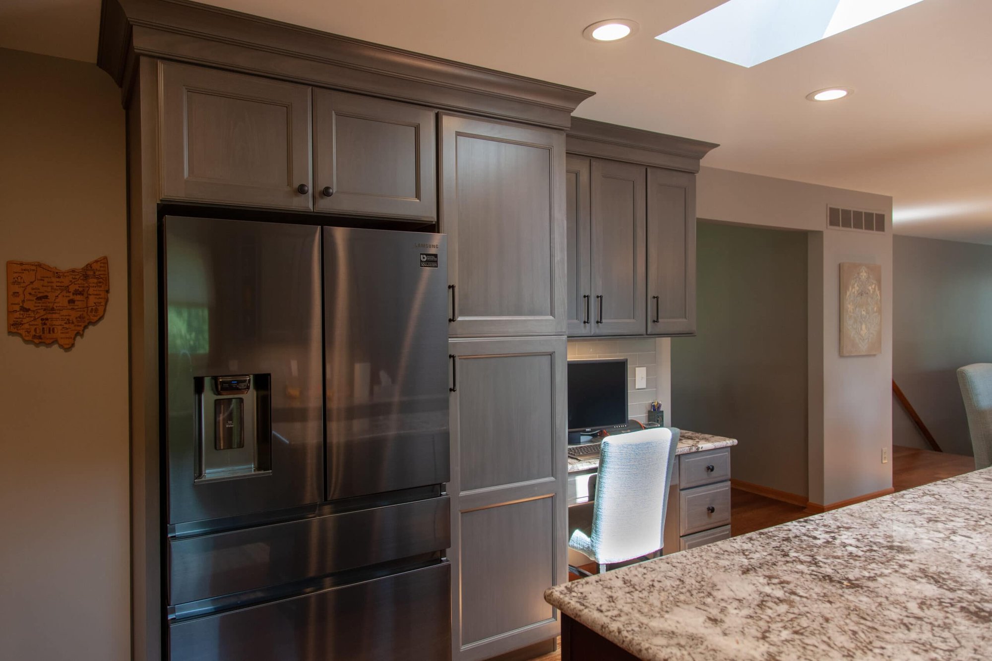 Kitchen remodel by Legacy Builders Group with custom pantry cabinets, quartz counters, and black appliances in Cincinnati, OH