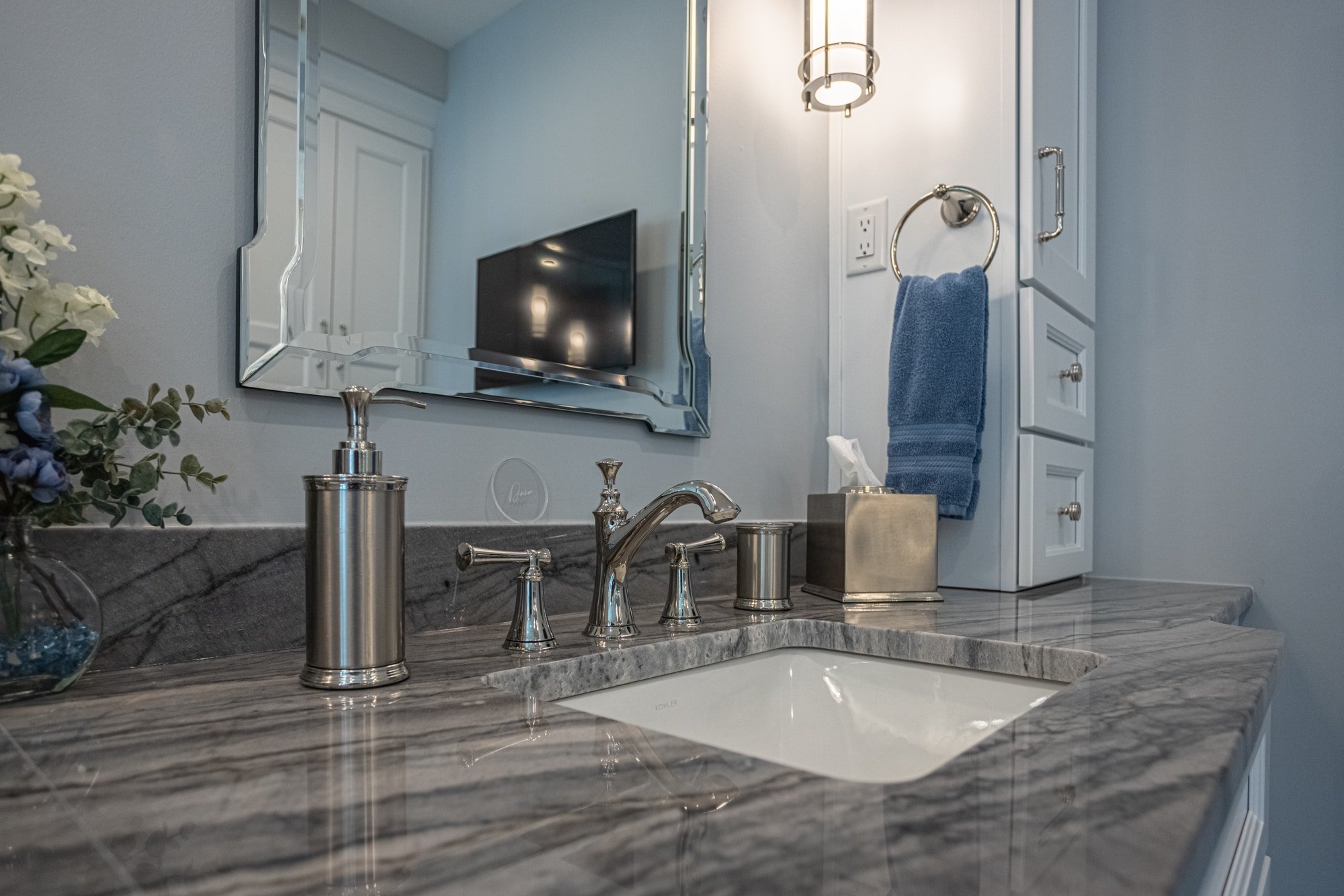 Marble countertop bathroom vanity with chrome faucet and mirror by Legacy Builders Group in Greater Cincinnati