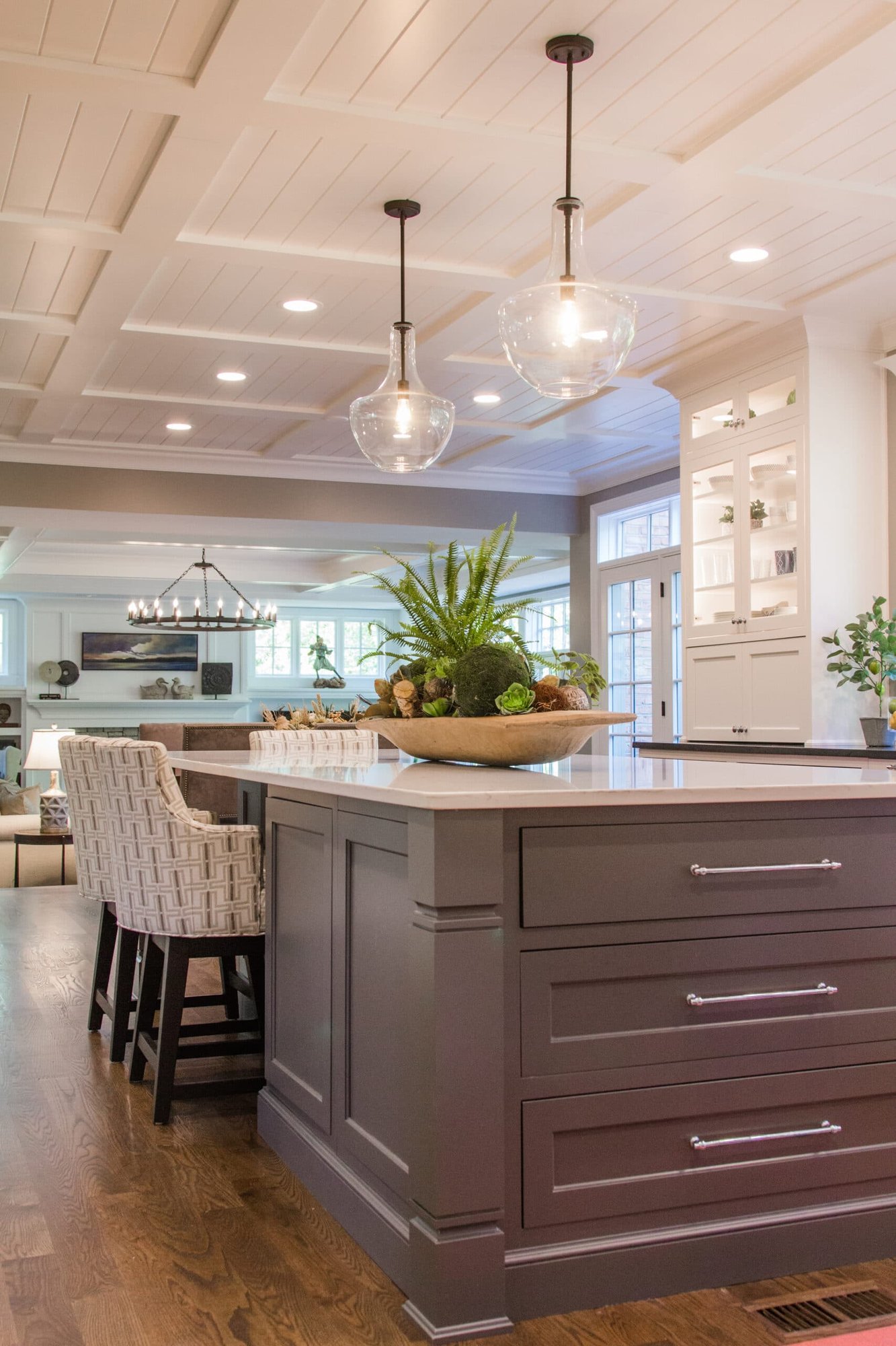 Montgomery, OH kitchen with gray island, glass pendants, coffered ceiling, bar seating, and built-in cabinets