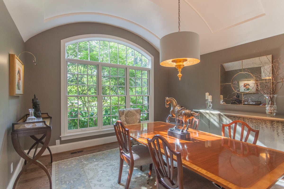 Montgomery, Ohio home addition by Legacy Builders with arched window in front of dining table 