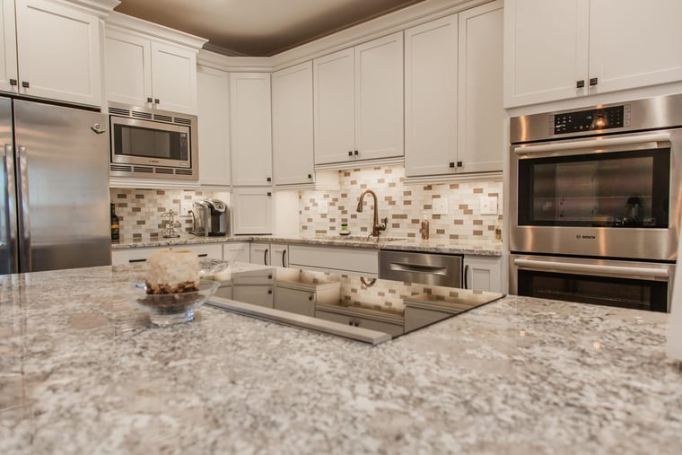 Mosaic backsplash behind under-cabinet lighting in Cincinnati kitchen remodel