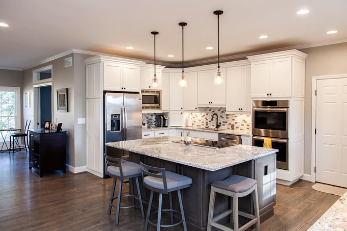 Open-concept Madeira, OH kitchen remodel with island beneath pendant lighting