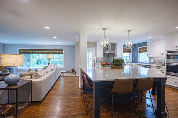 Open-concept ranch home interior with L-shaped kitchen and island with seating