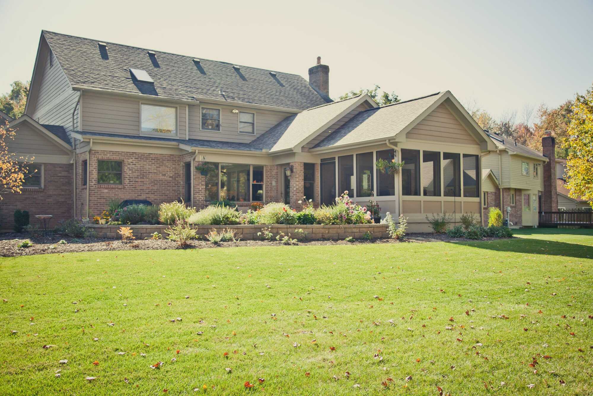 Rear view of home with screened porch addition and landscaped yard by Legacy Builders Group in Greater Cincinnati