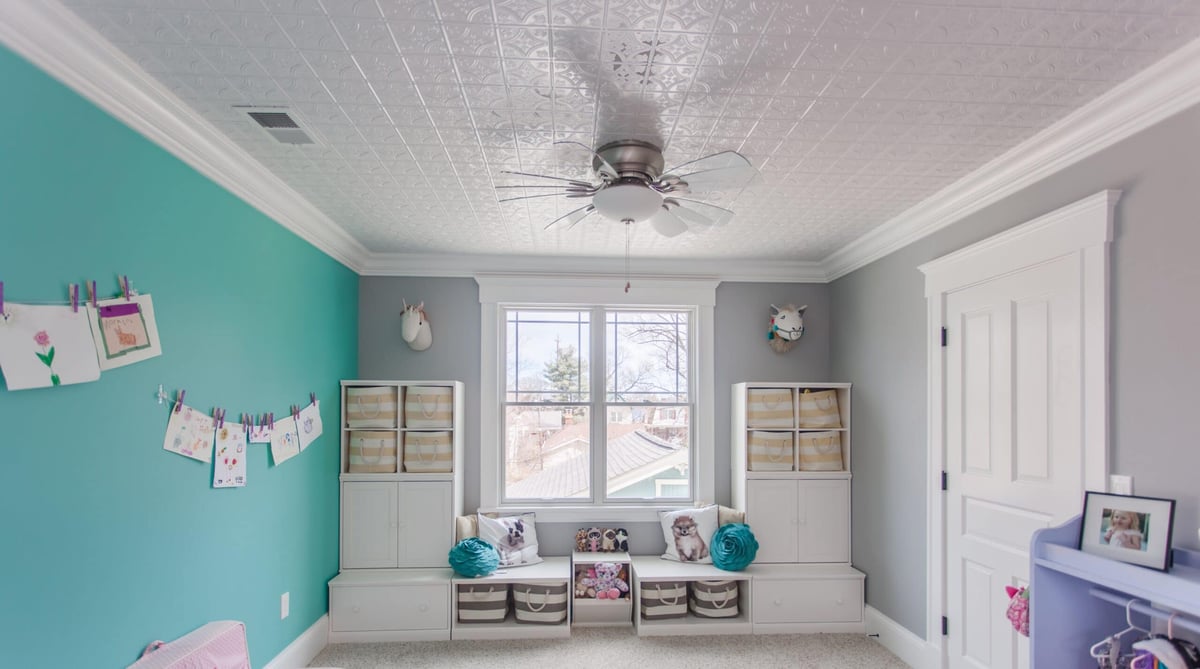 Second-story kid-friendly addition interior with window between bookshelves by Legacy Builders 