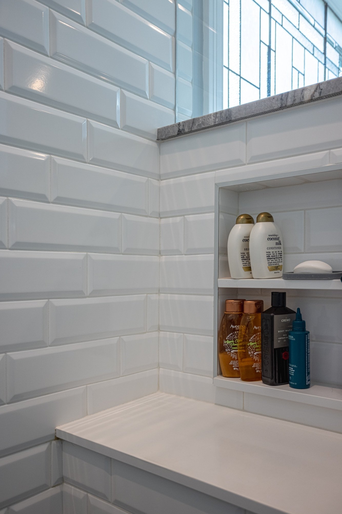 Shower niche with built-in shelves and white tile surround by Legacy Builders Group in Greater Cincinnati