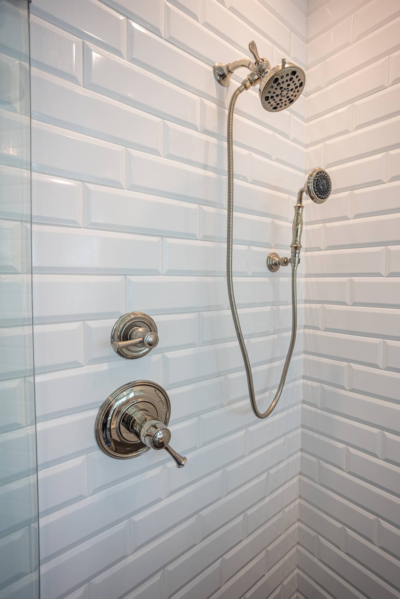 Shower with white subway tile and chrome fixtures by Legacy Builders Group in Greater Cincinnati