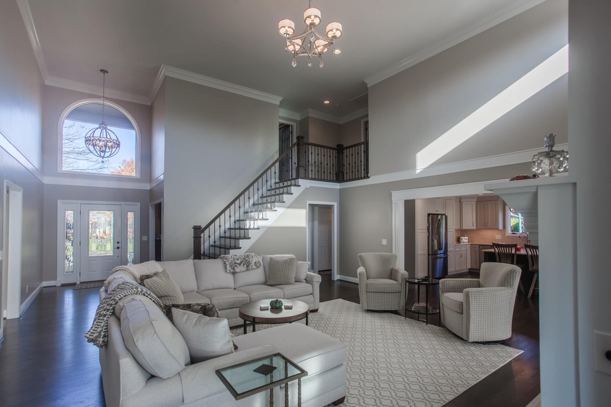 Spacious living room home addition with high ceilings, neutral tones, and open layout located in Cincinnati