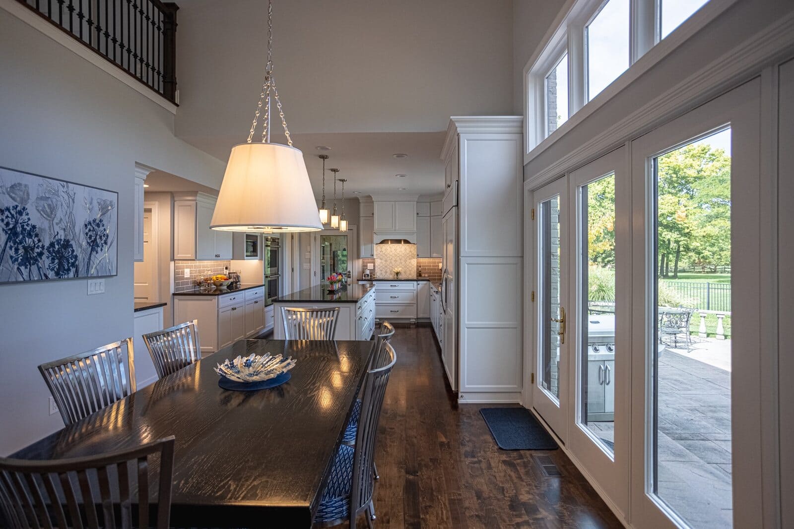 Main floor remodel view of kitchen and dining room with doors to patio