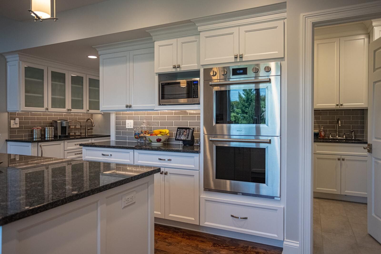 White shaker cabinets in kitchen remodel with double ovens