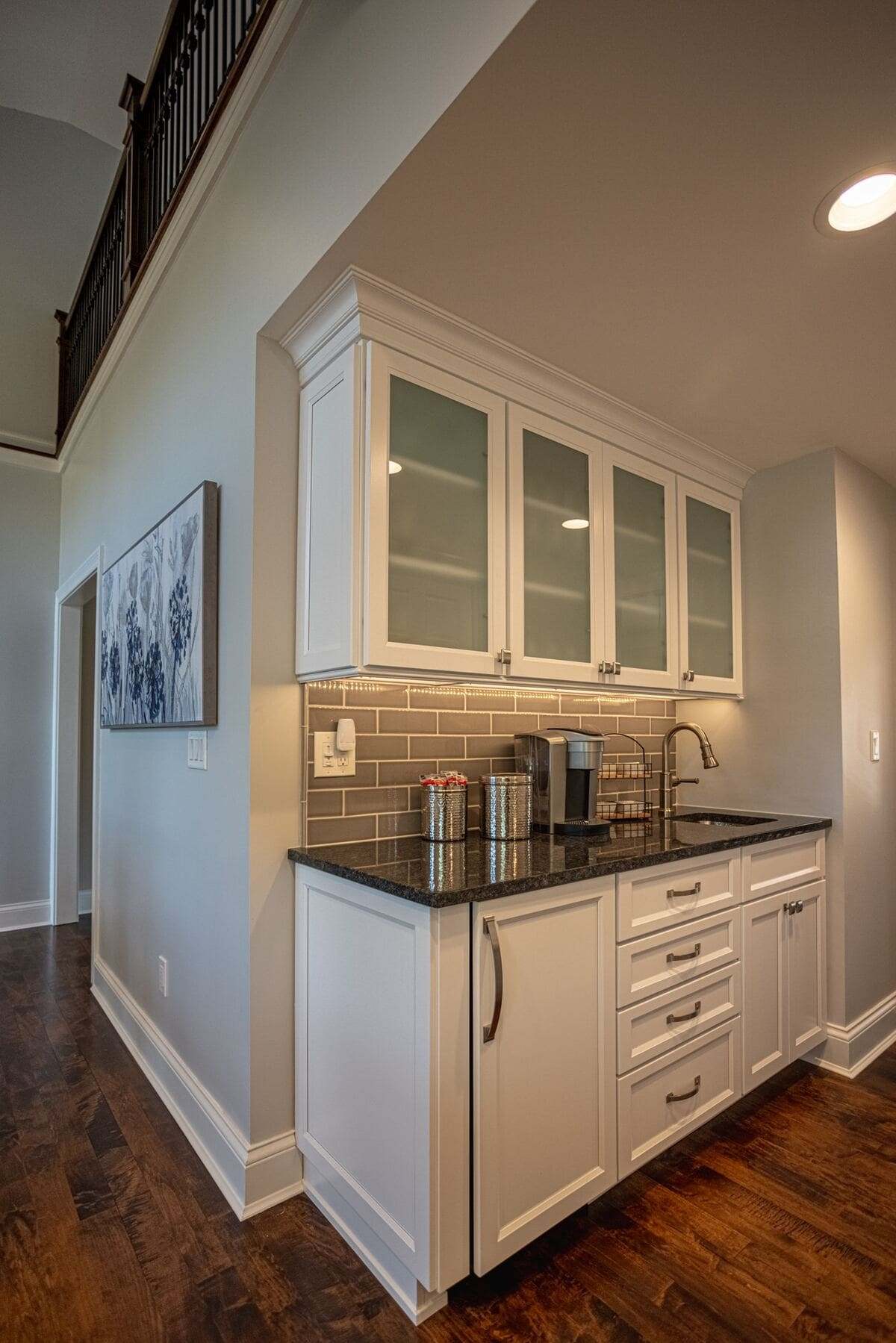 Custom beverage station and coffee bar with frosted window cabinets above