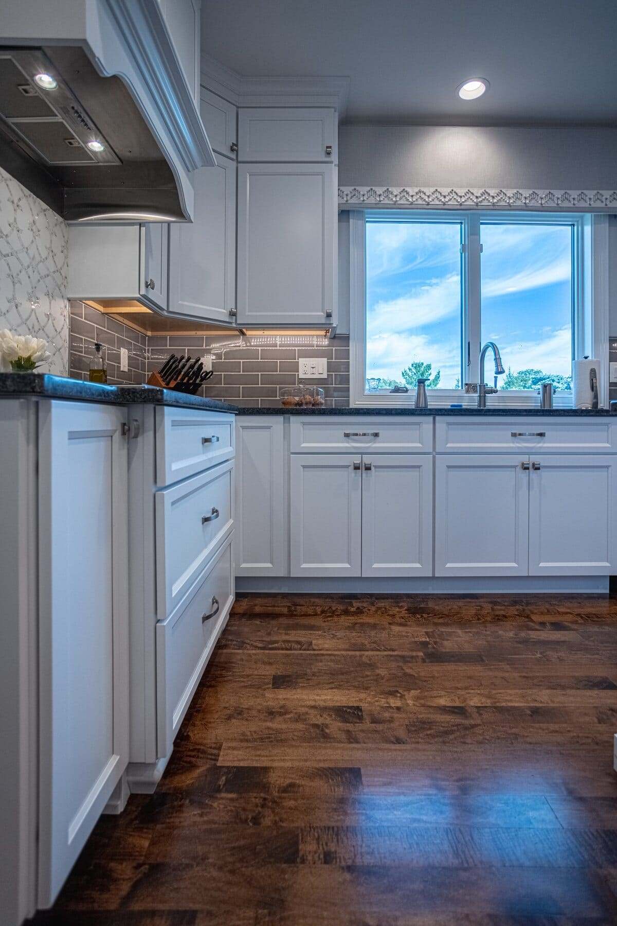 Maple flooring in kitchen with chrome cabinet pulls