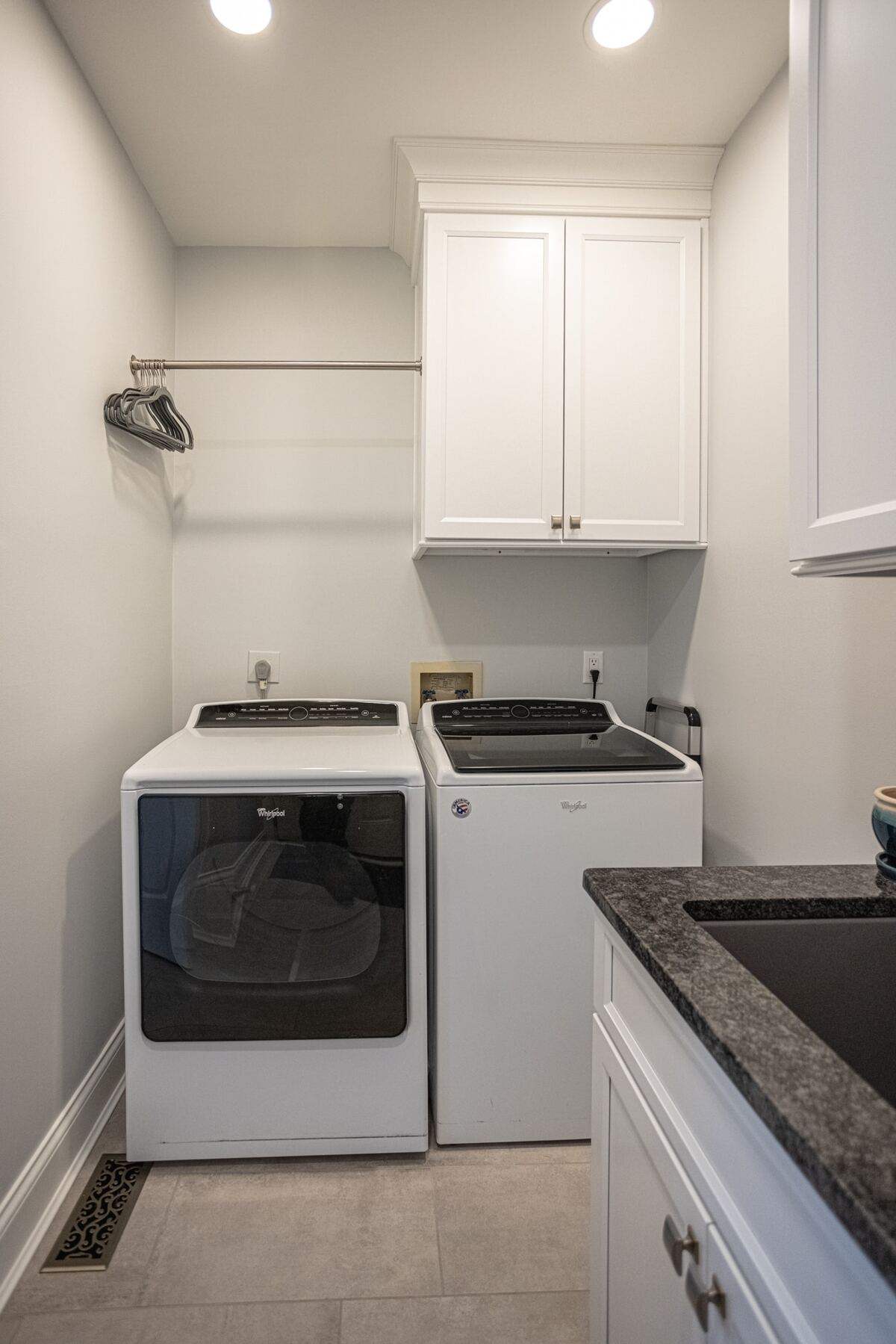 Laundry room remodel with custom white shaker cabinets and sink