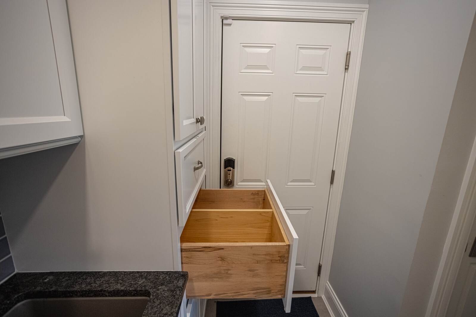 Custom shaker cabinet drawer pulled out in kitchen remodel