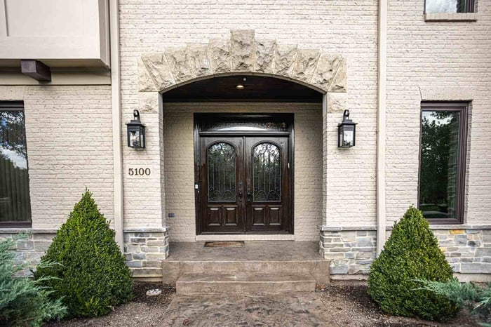 Exterior front entrance to home with victorian doors and archway
