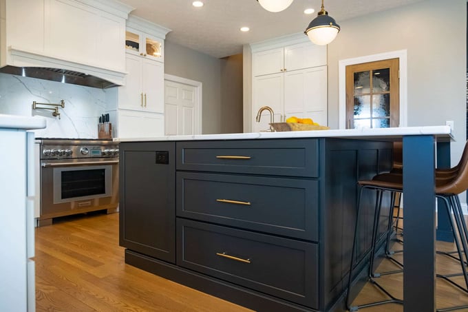 Kitchen island with brass cabinet pulls and sink