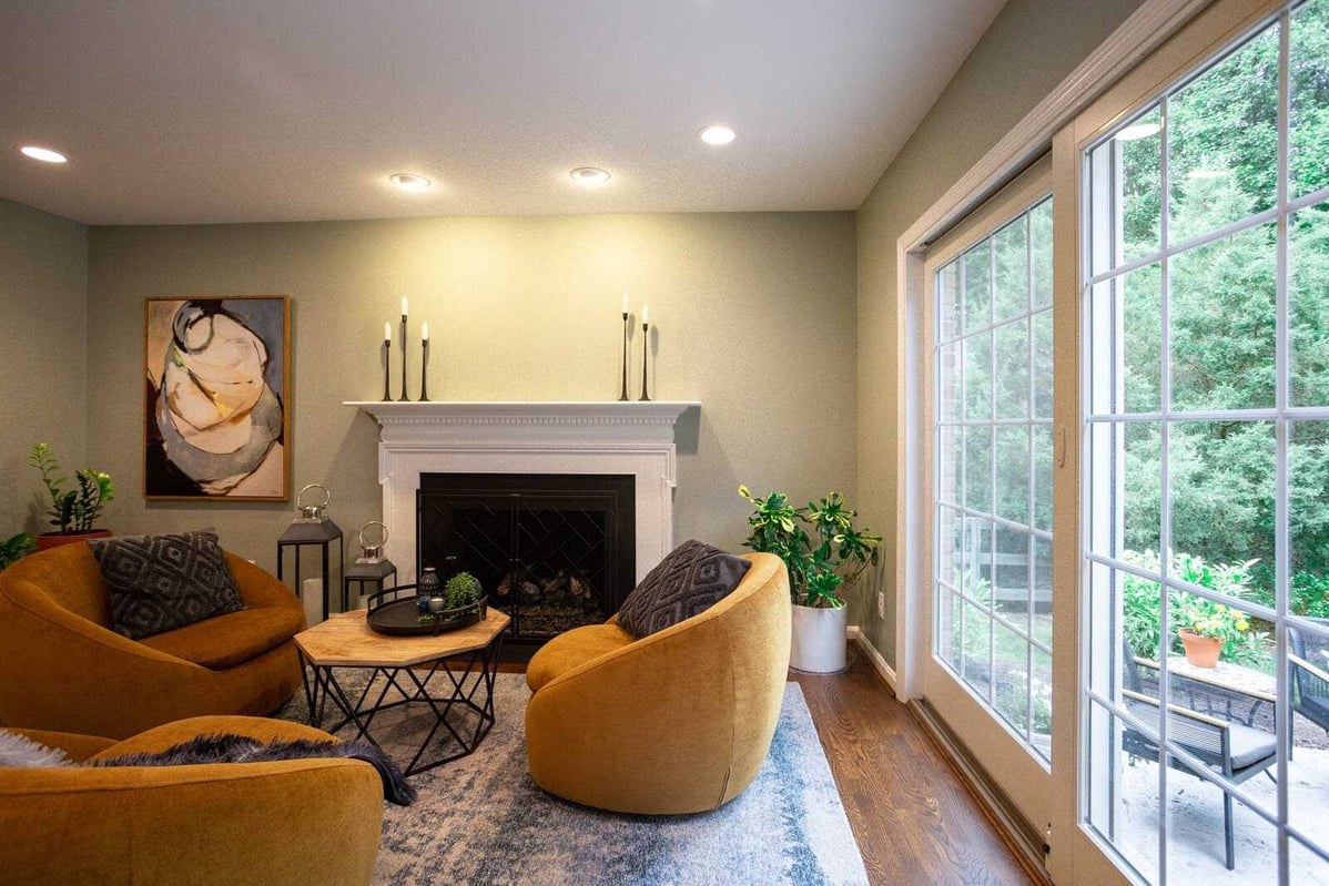 Living room area with custom fireplace and french windows to patio