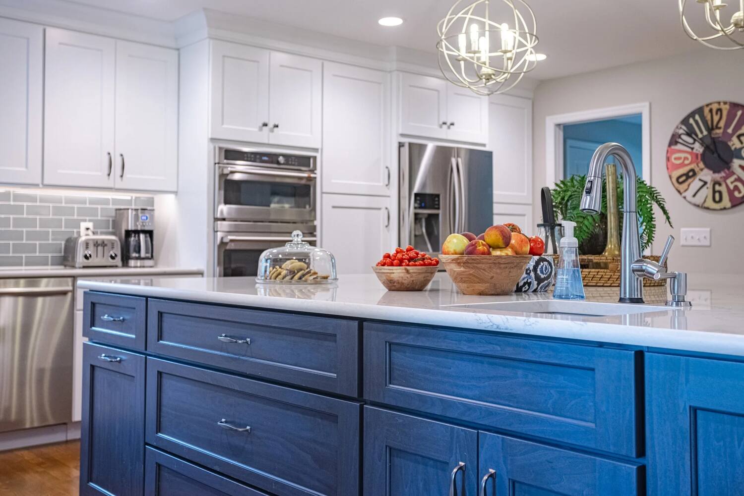 Navy blue kitchen island with white countertop and sink