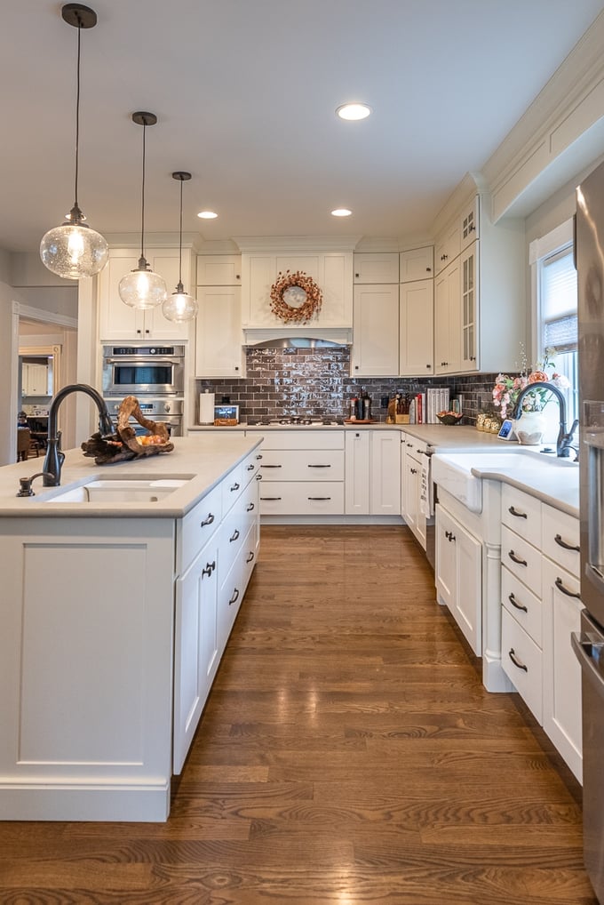 White kitchen with oak floors and two sinks