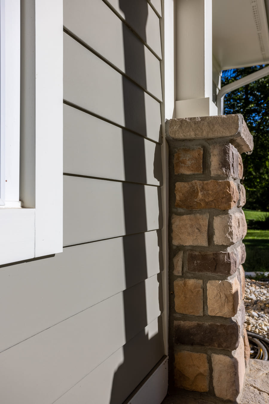 Fiber cement siding with stone veneers in front porch addition