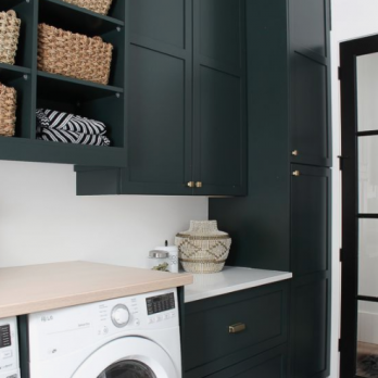 Laundry room with dark cabinets