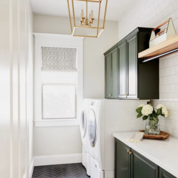 Small laundry room with white walls and dark cabinets