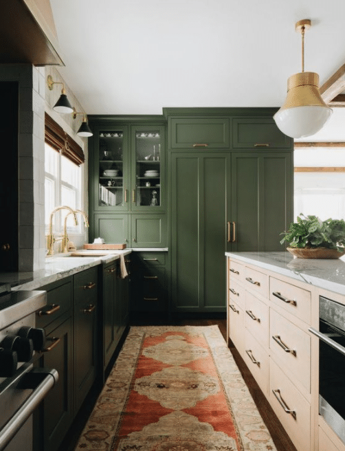 Kitchen with green cabinets and rug
