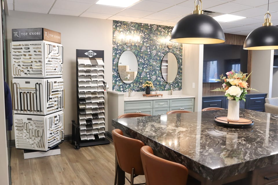 Legacy Builders Groups Cincinnati showroom featuring hardware displays, design samples, and a double vanity with floral wallpaper