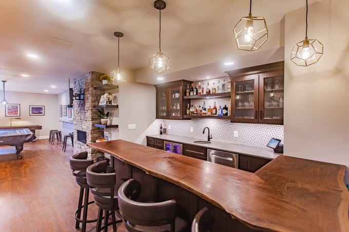 Transitional bar with unique cut of wood countertop in Cincinnati basement remodel