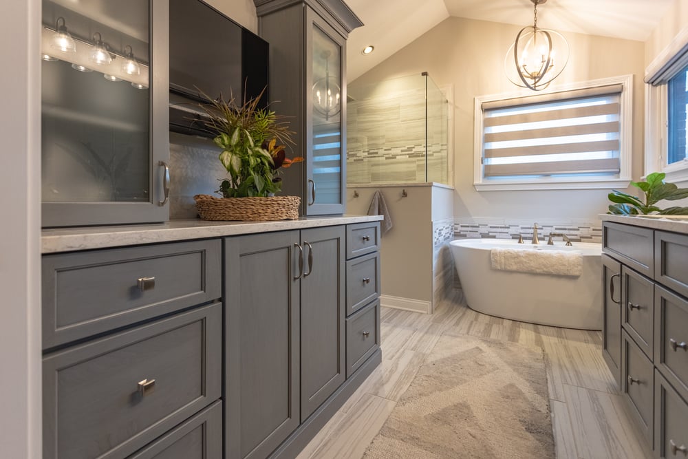 Master bathroom with ample storage, pendant lighting, walk-in shower and soaker tub by Legacy Builders Group in Cincinnati